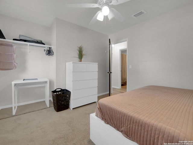 carpeted bedroom with ceiling fan, visible vents, and baseboards