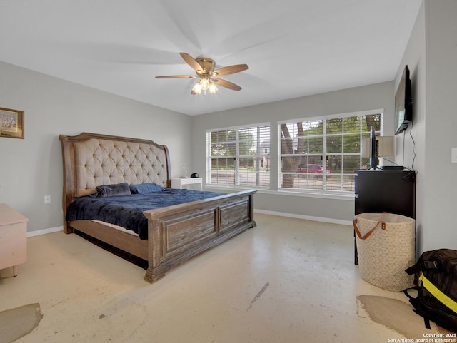 bedroom with baseboards, ceiling fan, and finished concrete floors