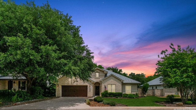 300 Knoll Spgs, Boerne, TX 78006 - view of front of house with concrete driveway, brick siding, an attached garage, and fence