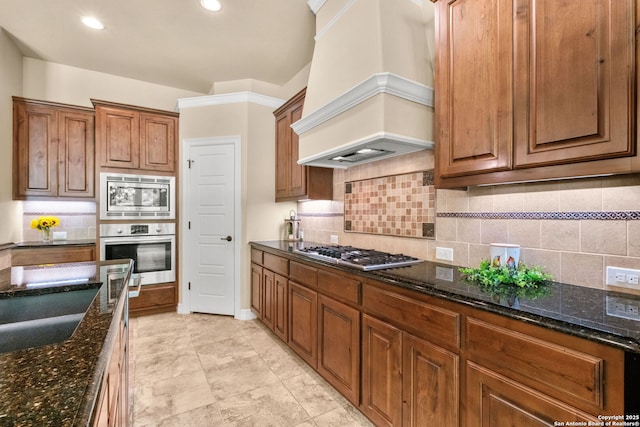 300 Knoll Spgs, Boerne, TX 78006 - kitchen with dark stone countertops, appliances with stainless steel finishes, custom exhaust hood, and tasteful backsplash