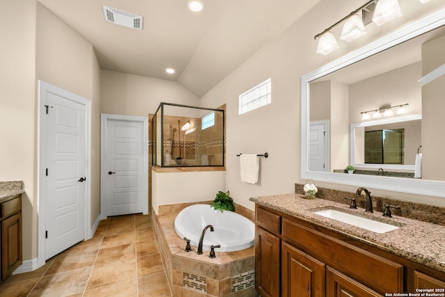 300 Knoll Spgs, Boerne, TX 78006 - full bathroom featuring a garden tub, visible vents, vaulted ceiling, a shower stall, and vanity