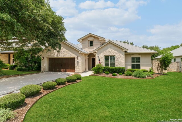 300 Knoll Spgs, Boerne, TX 78006 - view of front facade featuring driveway, a front yard, an attached garage, stone siding, and stucco siding