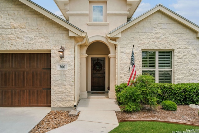 300 Knoll Spgs, Boerne, TX 78006 - property entrance with stucco siding, stone siding, and a garage