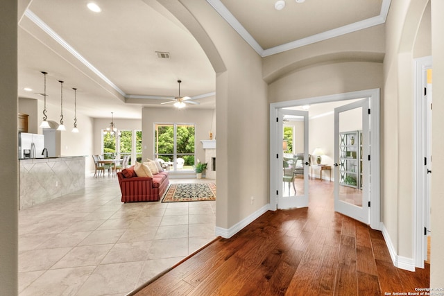 300 Knoll Spgs, Boerne, TX 78006 - entrance foyer with crown molding, ceiling fan, arched walkways, baseboards, and light wood-type flooring
