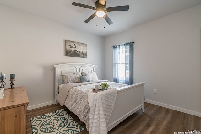 bedroom featuring a ceiling fan, baseboards, and dark wood finished floors