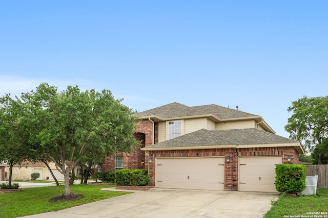 view of front facade with a front lawn, roof with shingles, brick siding, concrete driveway, and an attached garage