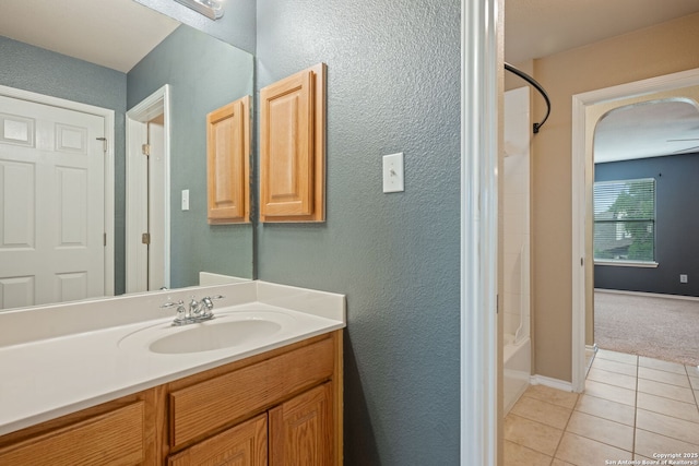 full bathroom featuring shower / bathtub combination, baseboards, tile patterned flooring, and vanity