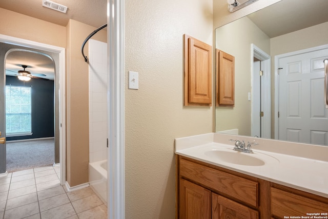 bathroom with visible vents, tile patterned flooring, vanity, baseboards, and ceiling fan
