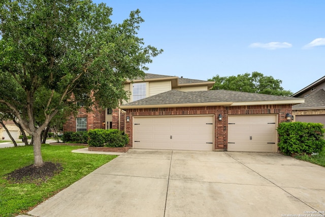 view of front facade with a front yard, roof with shingles, brick siding, an attached garage, and driveway