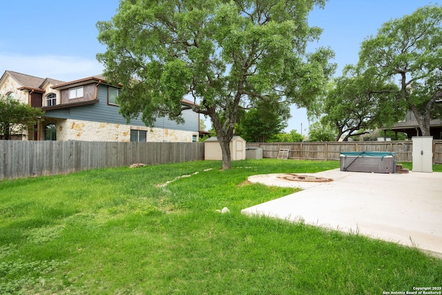 view of yard featuring a fenced backyard, an outbuilding, a patio area, and a shed