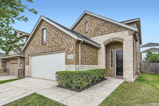 view of front of property featuring a front yard, brick siding, fence, concrete driveway, and stone siding