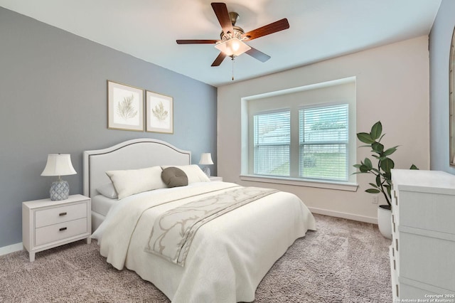 bedroom featuring baseboards, a ceiling fan, and light carpet