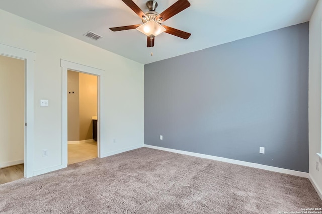 unfurnished bedroom with carpet flooring, a ceiling fan, baseboards, and visible vents