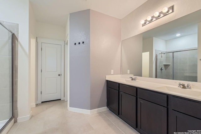 full bathroom featuring double vanity, tile patterned floors, a sink, and a stall shower