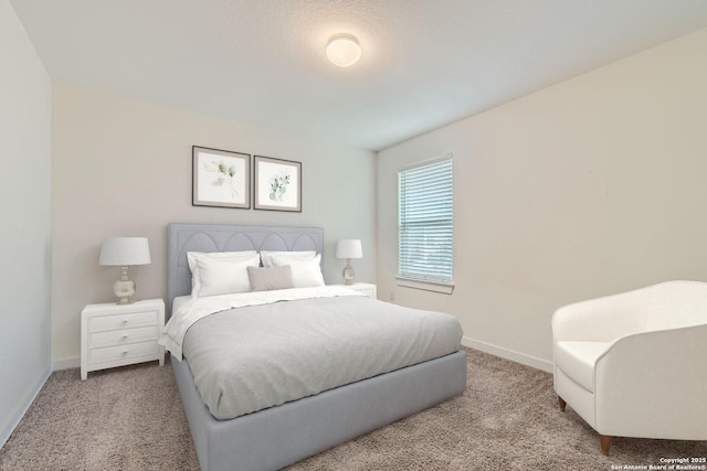 bedroom with carpet floors and baseboards