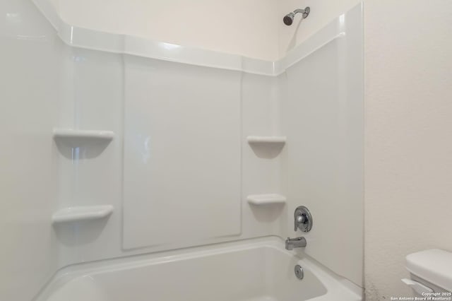 bathroom with toilet and  shower combination
