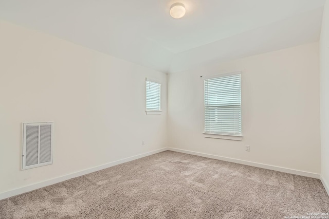unfurnished room with visible vents, carpet, and baseboards