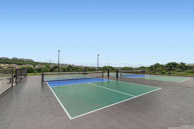 view of sport court featuring community basketball court and fence