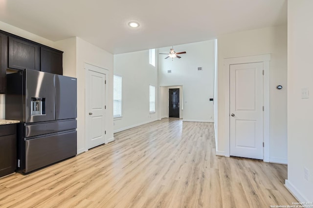 kitchen featuring ceiling fan, dark brown cabinetry, stainless steel refrigerator with ice dispenser, baseboards, and light wood finished floors