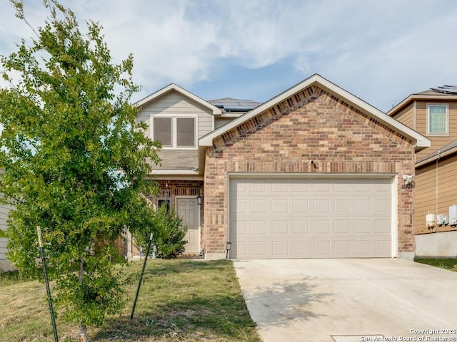 view of front of house with brick siding, an attached garage, driveway, and solar panels