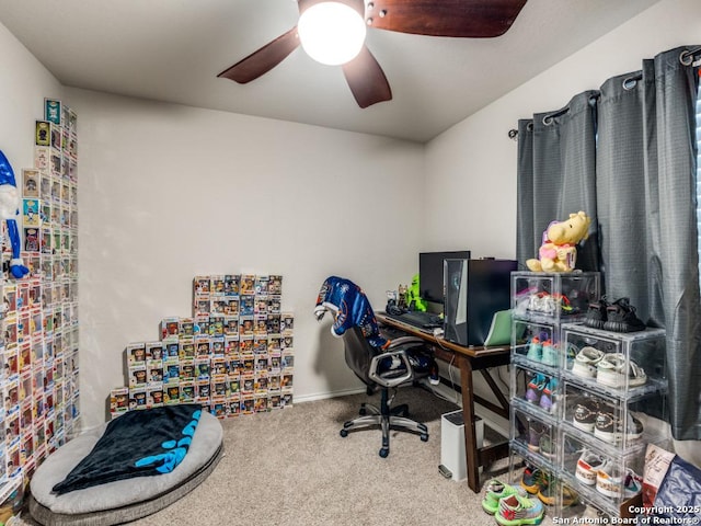 carpeted home office featuring a ceiling fan