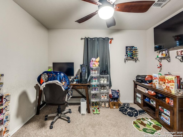 carpeted office featuring visible vents, baseboards, and ceiling fan