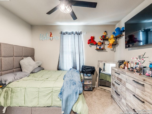 bedroom with a ceiling fan and light carpet