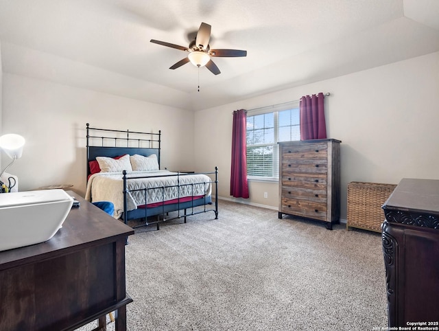 carpeted bedroom featuring baseboards and a ceiling fan