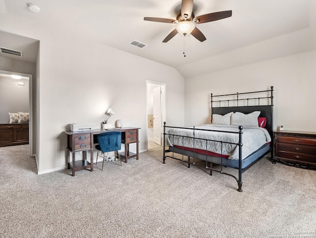 carpeted bedroom featuring visible vents, baseboards, lofted ceiling, and ensuite bath