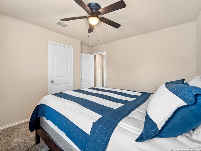 carpeted bedroom with visible vents, baseboards, and ceiling fan