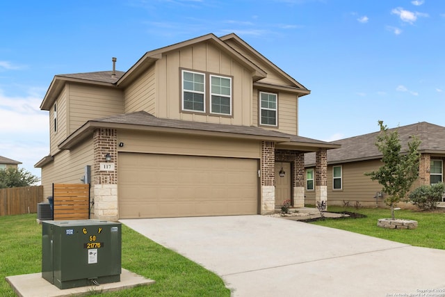 view of front of home with fence, an attached garage, board and batten siding, a front yard, and concrete driveway