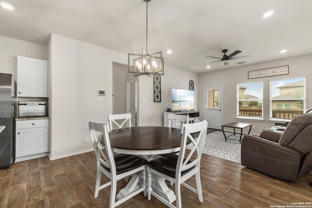 dining room with visible vents, baseboards, ceiling fan with notable chandelier, recessed lighting, and dark wood-type flooring