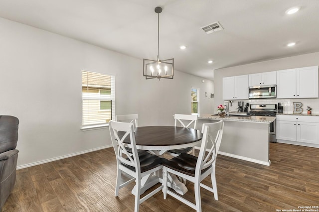 dining area with visible vents, dark wood finished floors, and a healthy amount of sunlight