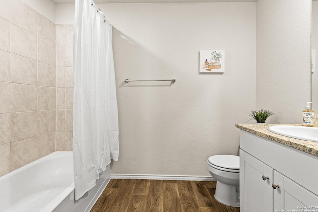full bath featuring vanity, shower / tub combo with curtain, toilet, baseboards, and wood finished floors