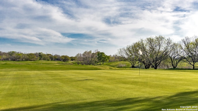 surrounding community with a lawn and golf course view