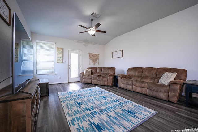 living room with a ceiling fan, baseboards, vaulted ceiling, visible vents, and dark wood-style floors