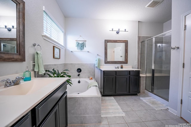 bathroom with visible vents, a sink, a garden tub, and a stall shower