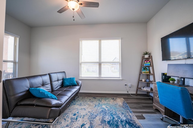 living area with baseboards, ceiling fan, and wood finished floors