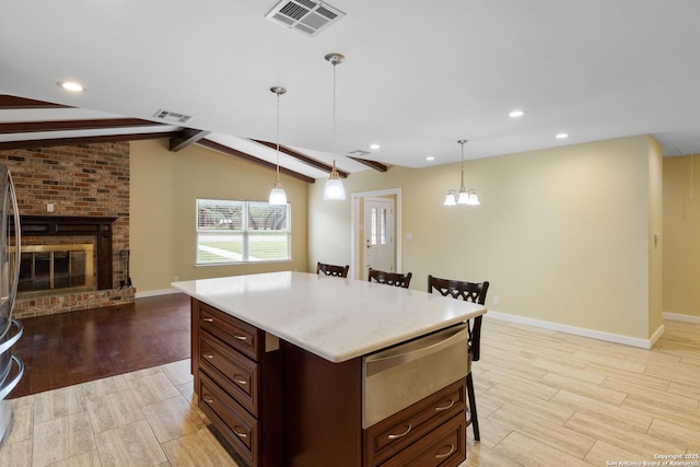 kitchen with a warming drawer, light wood-style flooring, and visible vents