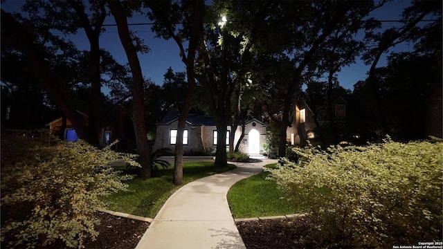 view of property's community with a lawn