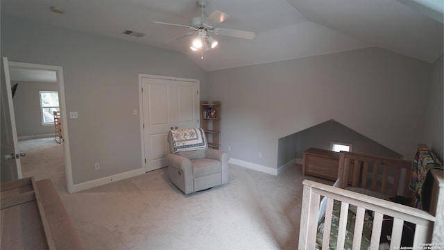 bedroom featuring light colored carpet, visible vents, a ceiling fan, baseboards, and vaulted ceiling