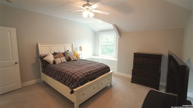 bedroom with a ceiling fan, baseboards, light carpet, and lofted ceiling
