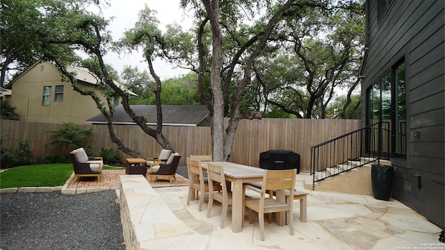 view of patio / terrace with outdoor dining space and a fenced backyard