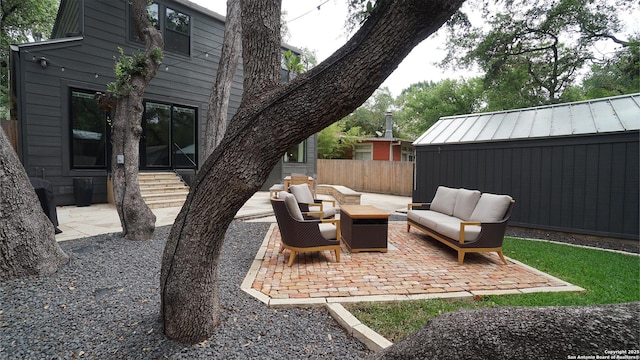 view of patio featuring outdoor lounge area and fence
