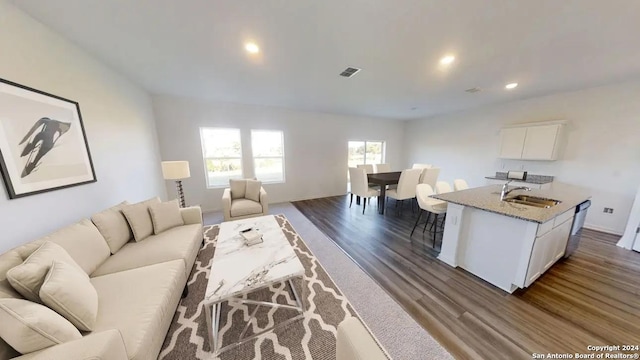 living room featuring dark wood-type flooring, recessed lighting, and visible vents
