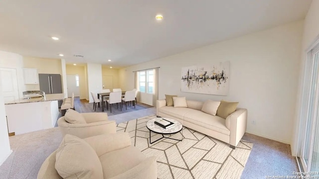living room featuring recessed lighting and light carpet