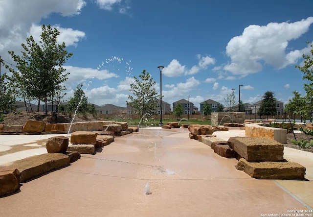 surrounding community with a patio and a residential view