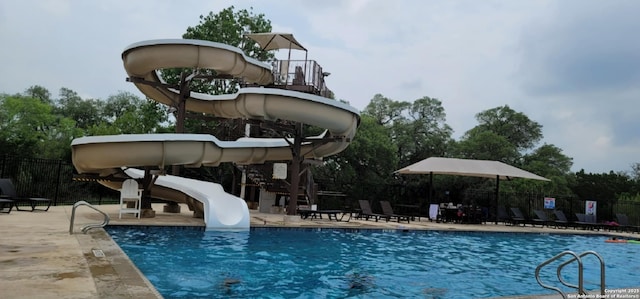 12518 Crockett Way, San Antonio, TX 78253 - community pool with fence, a water slide, and a patio