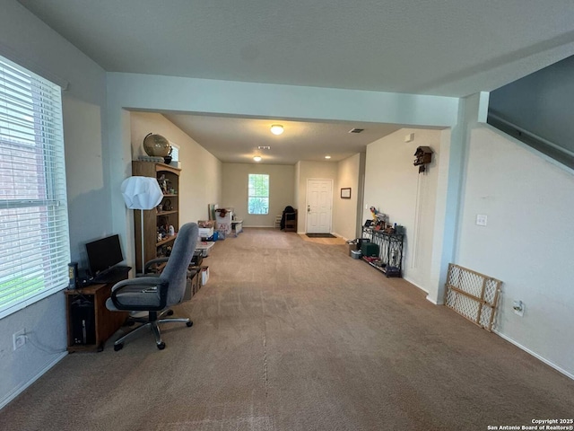 home office with baseboards, visible vents, and carpet
