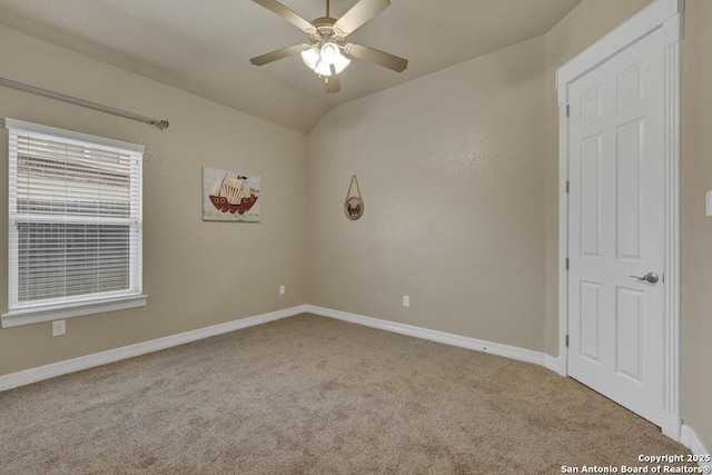 unfurnished room featuring ceiling fan, lofted ceiling, baseboards, and carpet
